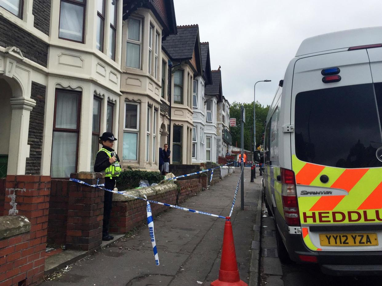 A police officer stands outside a property in Pen-y-Wain Road, Roath, Cardiff: Johanna Carr/PA