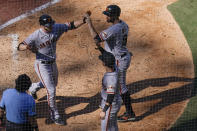 San Francisco Giants' Austin Slater, top left, celebrates with teammates Brandon Belt, top right, and Tommy La Stella, bottom right, after hitting a home run during the sixth inning of a baseball game against the San Diego Padres, Thursday, Sept. 23, 2021, in San Diego. (AP Photo/Gregory Bull)