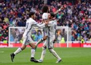 Real Madrid's Marcelo (C) celebrates a goal with teammates during their Spanish league football match against Valencia at the Santiago Bernabeu stadium in Madrid on April 29, 2017