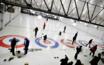 Refugees learn the sport of curling at the Royal Canadian Curling Club during an event put on by the "Together Project", in Toronto, March 15, 2017. REUTERS/Mark Blinch