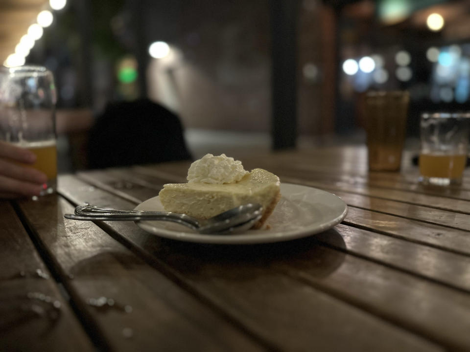 <p>A wider Portrait mode photo from the iPhone 14 Pro's main camera of a key lime pie on a table at night.</p>
