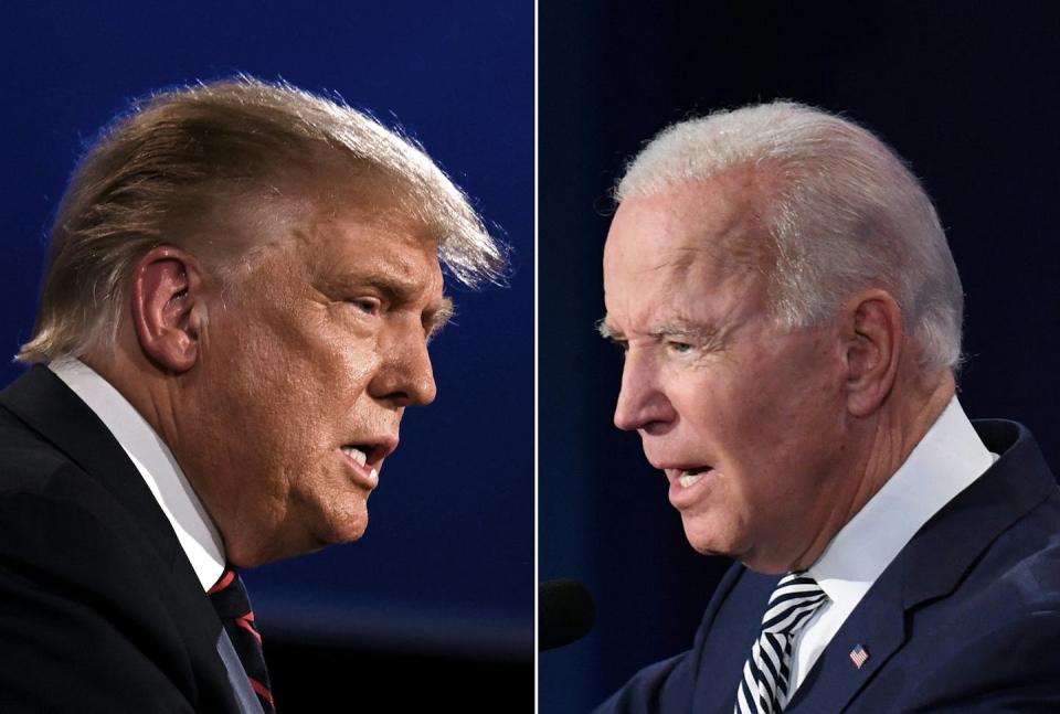 An image showing two white middle-aged men dressed in business suits debating each other.