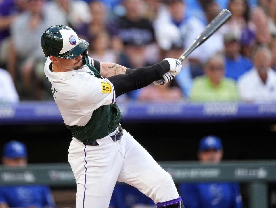 Colorado Rockies' Brenton Doyle follows through with his swing after connecting for a two-run home run off Kansas City Royals starting pitcher Seth Lugo in the second inning of a baseball game Saturday, July 6, 2024, in Denver. (AP Photo/David Zalubowski)