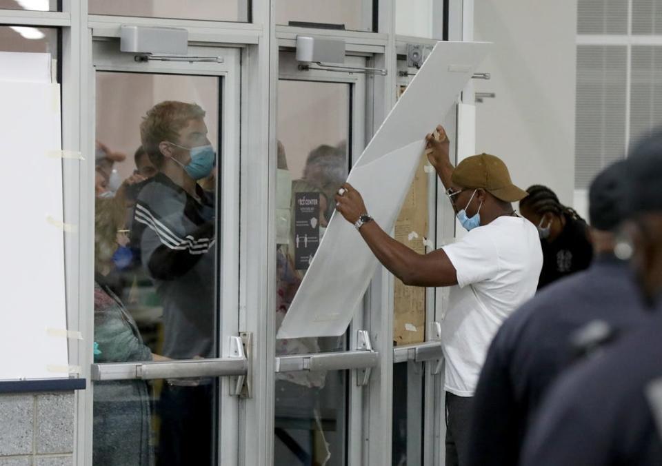 Large pieces of cardboard were taped up to prevent people from taking photos and videos of the ballot counting area at the TCF Center in Detroit on Wednesday, Nov. 4, 2020.