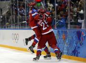 Russia's Iya Gavrilova (R, obscured) celebrates her goal against Germany with teammates Anna Shokhina (29) and Yekaterina Smolentseva during the third period of their women's ice hockey game at the Sochi 2014 Sochi Winter Olympics, February 9, 2014. REUTERS/Jim Young (RUSSIA - Tags: SPORT OLYMPICS ICE HOCKEY TPX IMAGES OF THE DAY) ATTENTION EDITORS: PICTURE 20 OF 25 FOR PACKAGE 'SOCHI - EDITOR'S CHOICE' TO FIND ALL IMAGES SEARCH 'EDITOR'S CHOICE - 09 FEBRUARY 2014'