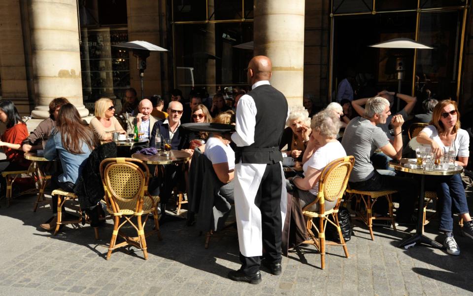 Customers and waiter at Café Life Paris, France