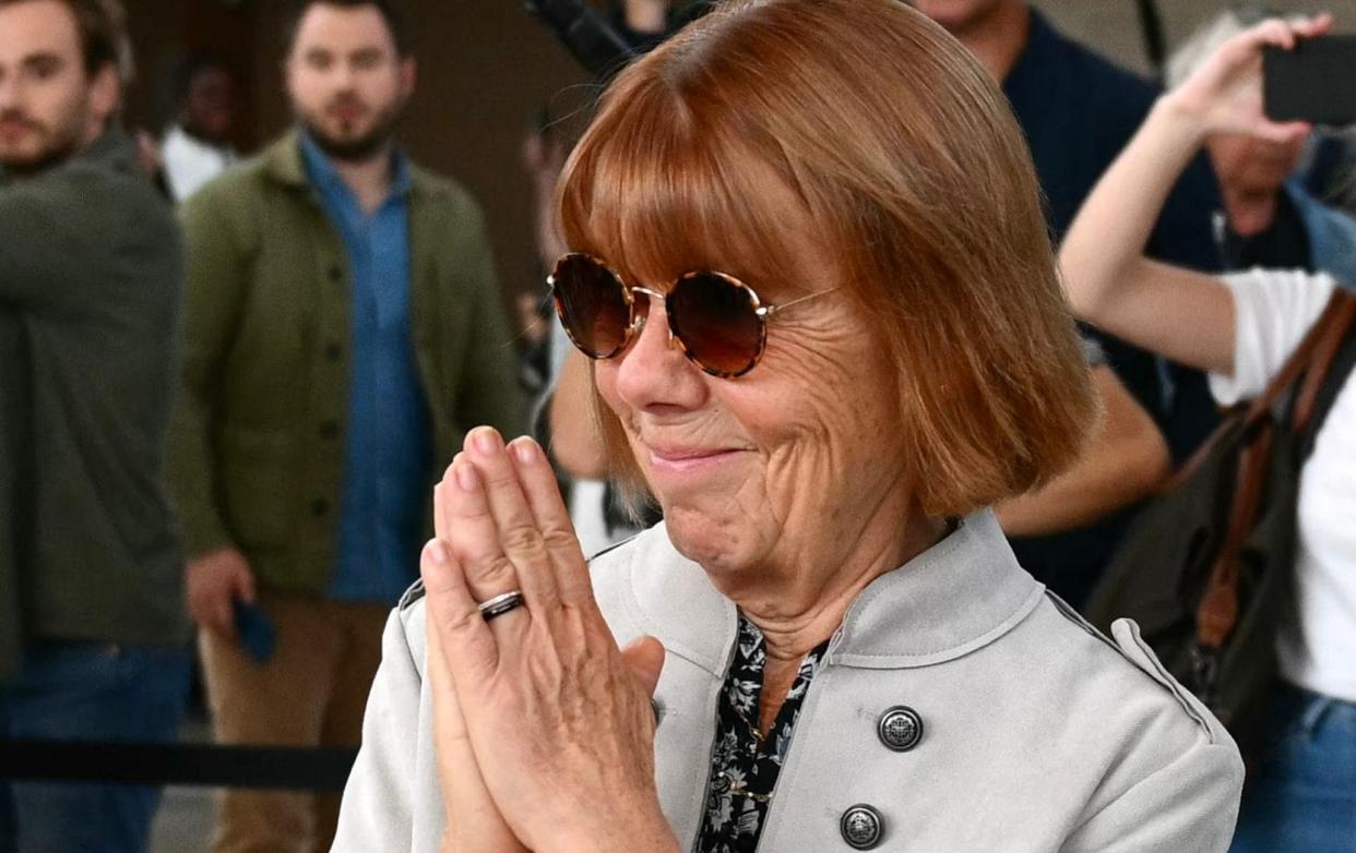 Gisele Pélicot acknowledges applause as she exits the courtroom in Avignon