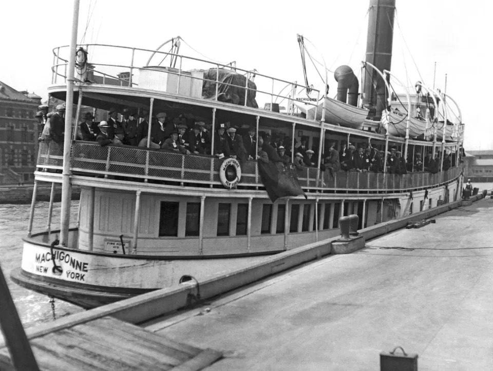 Immigrants arrive at Ellis Island in 1923, one year before Congress reformed immigration laws in the U.S., making it harder to enter the country. <a href=