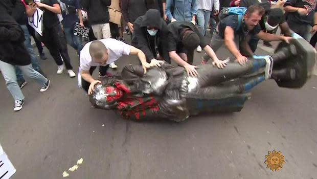 Protesters torn down a statue commemorating slave trader Edward Colston in Bristol, England, before pitching it into the harbor, June 7, 2020.  / Credit: CBS News