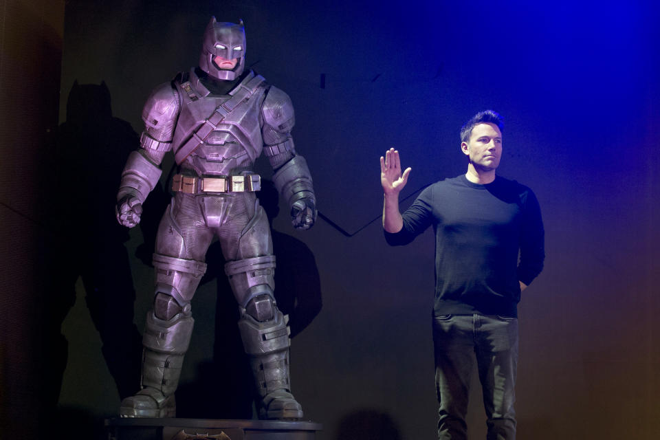 Actor Ben Affleck poses with a statue of Batman during a press conference for the movie "Batman v Superman: Dawn of Justice" in Beijing, China, Friday, March 11, 2016. (AP Photo/Ng Han Guan)