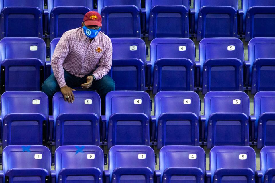 Nate Carr cheers as his son wrestles during a Big 12 Conference wrestling dual against Oklahoma in 2021