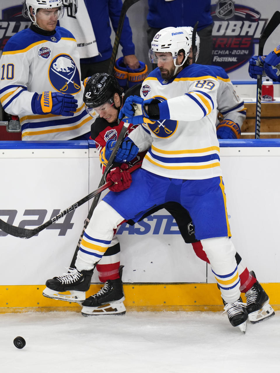 Buffalo Sabres' Alex Tuch, right, challenges New Jersey Devils' Curtis Lazar during the NHL hockey game between Buffalo Sabres and New Jersey Devils, in Prague, Czech Republic, Saturday, Oct. 5, 2024. (AP Photo/Petr David Josek)