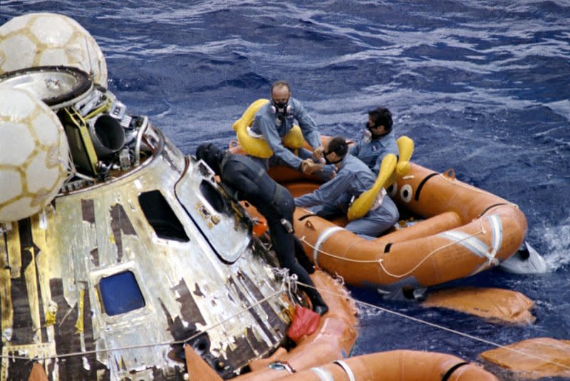 A U.S. Navy underwater demolition team swimmer assists the Apollo 12 crew during recovery operations in the Pacific Ocean on November 24, 1969. File Photo courtesy of NASA