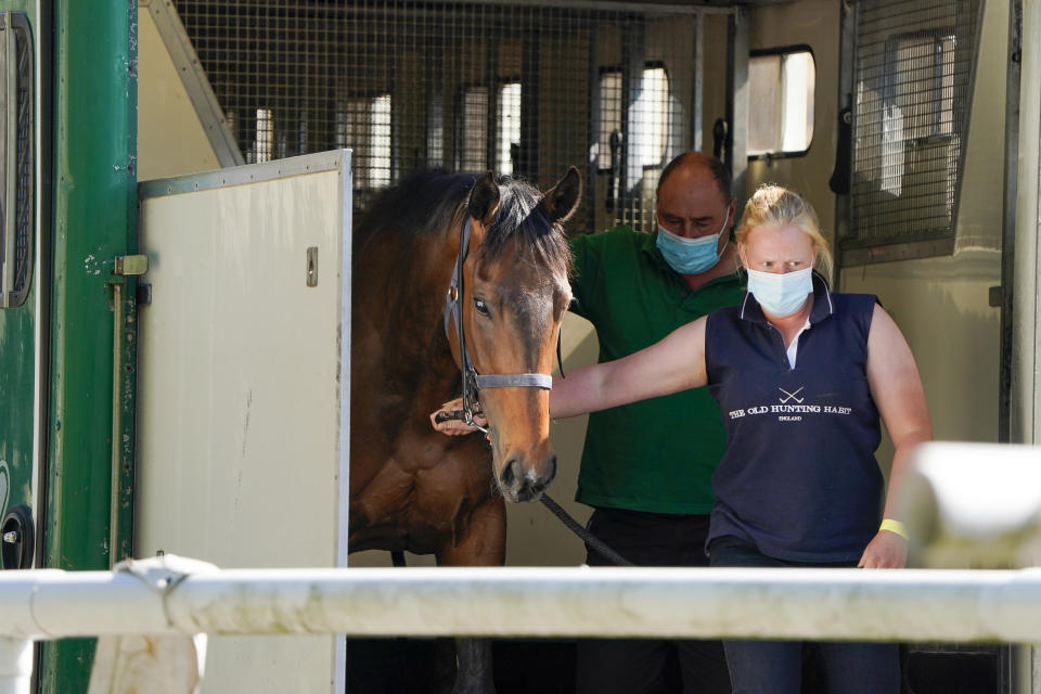 A groom leads a racehorse to the stables after arriving at Newcastle Racecourse . Issue date: Monday June 1, 2020. Horse Racing in the UK returned to action on Monday following the coronavirus shutdown. See PA story RACING Newcastle. Photo credit should read: Alan Crowhurst/PA Wire