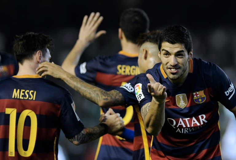 Barcelona's forward Luis Suarez (R) celebrates after scoring a goal during the Spanish league match against Real Betis in Sevilla on April 30, 2016