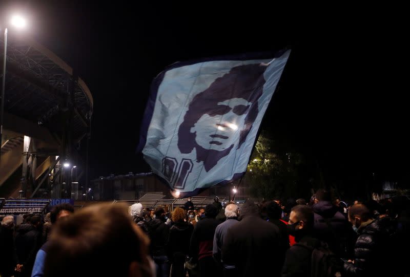 People gather to mourn the death of Argentine soccer legend Diego Maradona outside San Paolo stadium in Naples