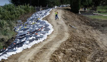 <p>A worker walks across a levee near the Cedar River, Monday, Sept. 26, 2016, in Cedar Rapids, Iowa. (AP Photo/Charlie Neibergall)</p>