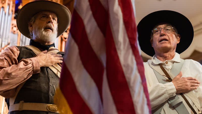 Val John Halford, left, a member of the Mormon Battalion Association, and Greg Christofferson, president of the Mormon Battalion Association, recite the Pledge of Allegiance at the Days of ’47 Sunrise Service at the Assembly Hall on Temple Square in Salt Lake City on July 24, 2023.