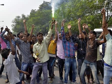 Supporters of Janata Dal (United) and Rashtriya Janata Dal celebrate after learning of initial election results on a street in Patna, India, November 8, 2015. REUTERS/Stringer