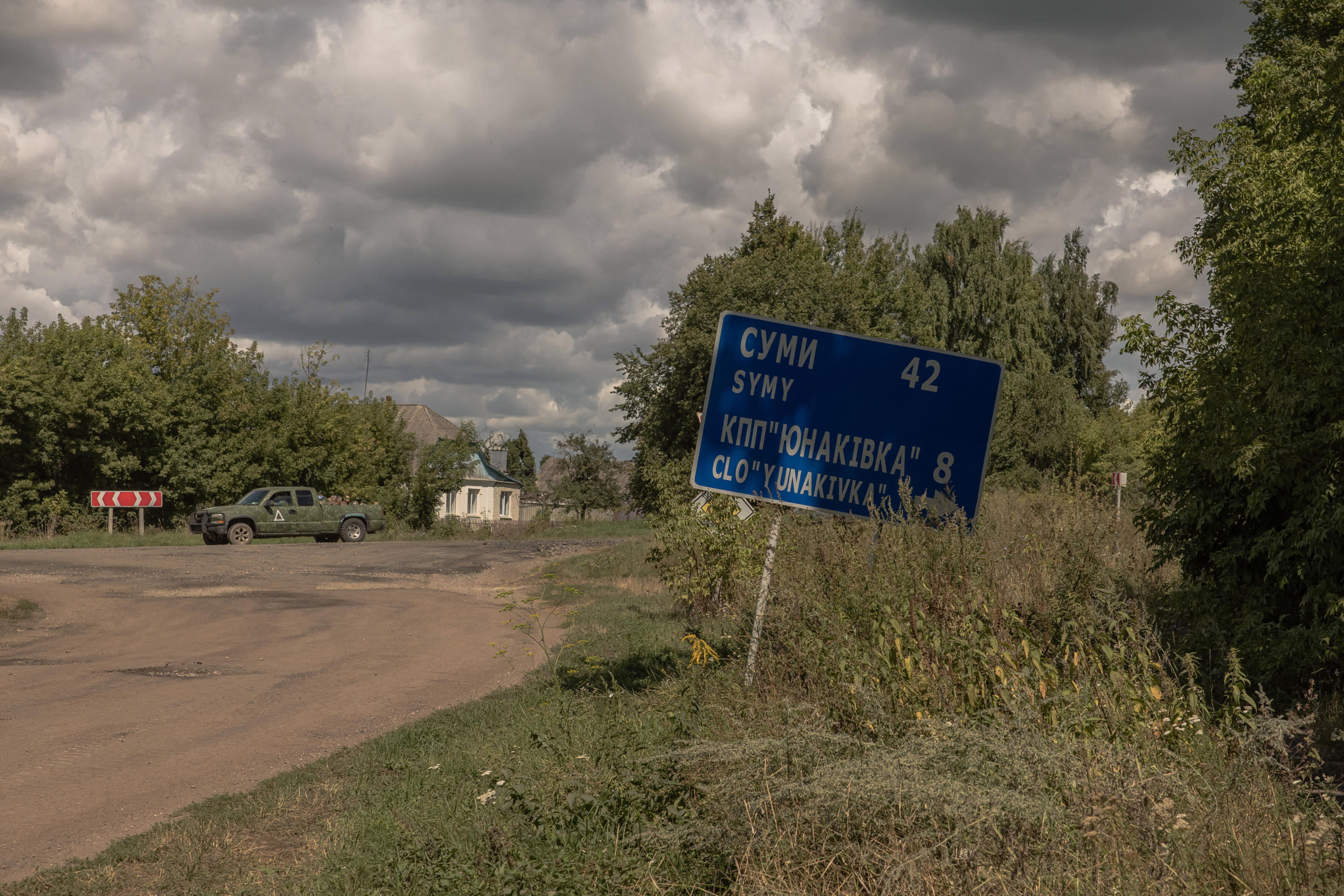 A Ukrainian military vehicle drives from the direction of the Russian border carrying blindfolded men in Russian military uniforms. 