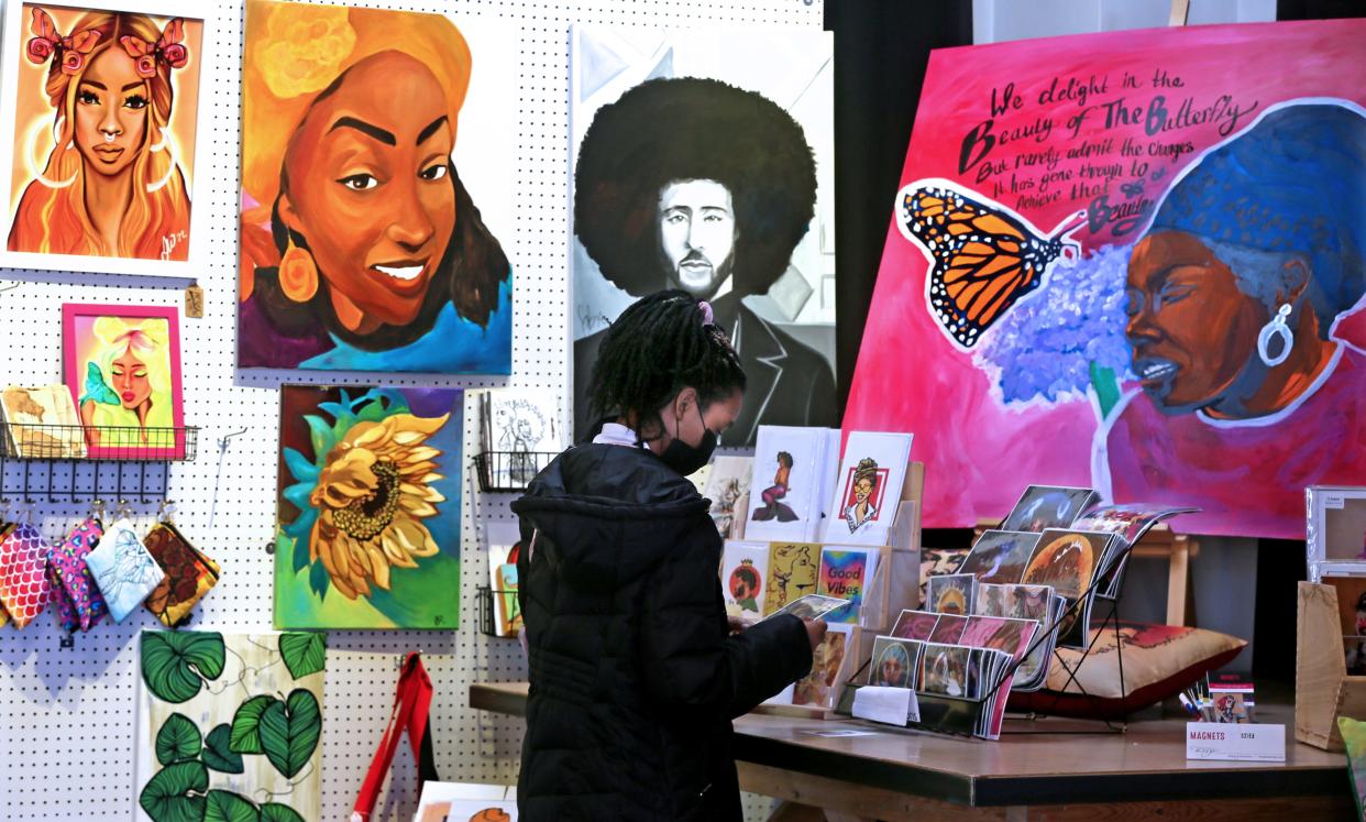 Amelu Ruff from Spokane, Washington, looks at cards while shopping at Bronzeville Collective on Friday, Nov. 25, 2022 on at 339 W. North Ave., in Milwaukee. Ruff is in town for the Thanksgiving holiday visiting family.