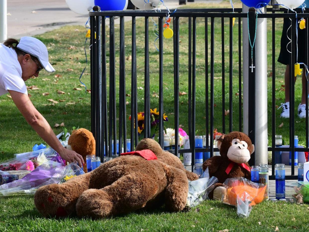 A candle is placed at a makeshift memorial in Central Park, not far from Saugus High School: AFP via Getty Images