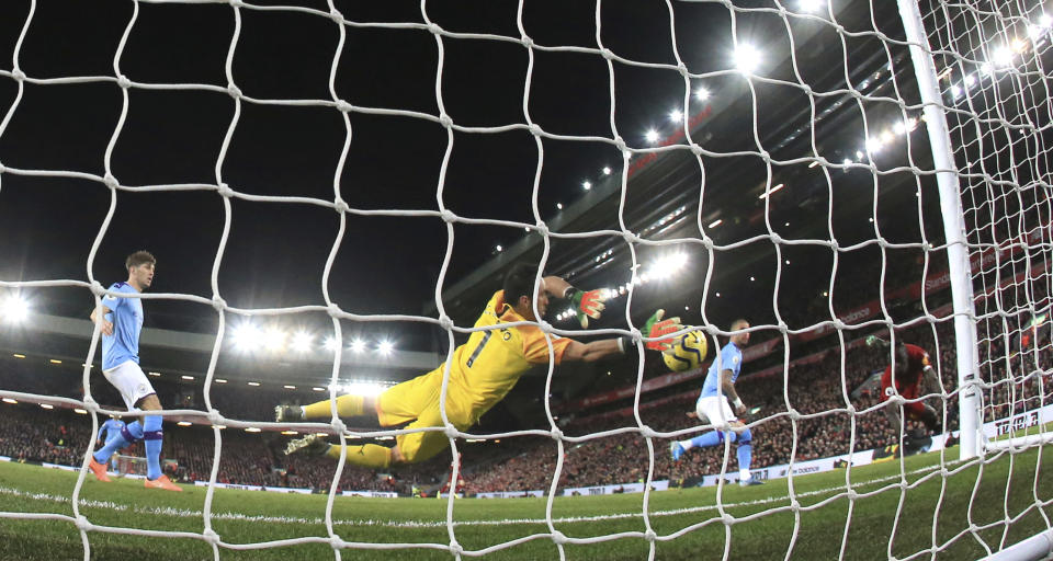 Liverpool's Sadio Mane, right, heads the ball to score his side's third goal during the English Premier League soccer match between Liverpool and Manchester City at Anfield stadium in Liverpool, England, Sunday, Nov. 10, 2019. (AP Photo/Jon Super)