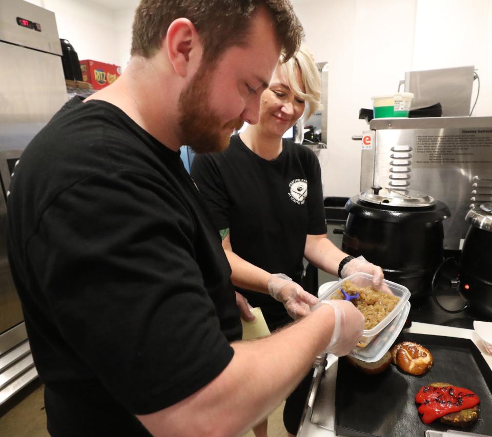 John Hawkins works with his sister Andi Lisy in the kitchen at Crafted Eats at Ignite Brewing Co.