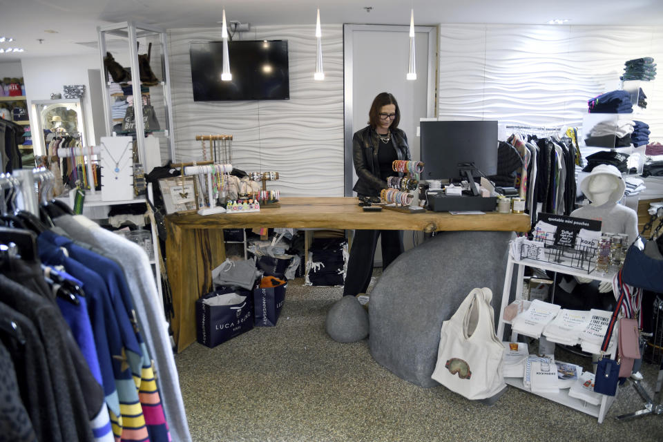 Jenn Bruno works in her boutique clothing store in Vail, Colo., on Oct. 25, 2022. Bruno, a former town council member, has had a hard time hiring workers because of an extreme housing crunch in the ski resort town. (AP Photo/Thomas Peipert)