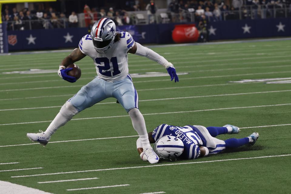 Dallas Cowboys' Ezekiel Elliott (21) runs against Indianapolis Colts' Rodney McLeod (26) during the second half of an NFL football game, Sunday, Dec. 4, 2022, in Arlington, Texas. (AP Photo/Ron Jenkins)
