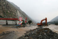 Workers clear debris after the Rimac river overflowed near the Central Highway in Huarochiri, Lima, Peru, March 23, 2017. REUTERS/Guadalupe Pardo