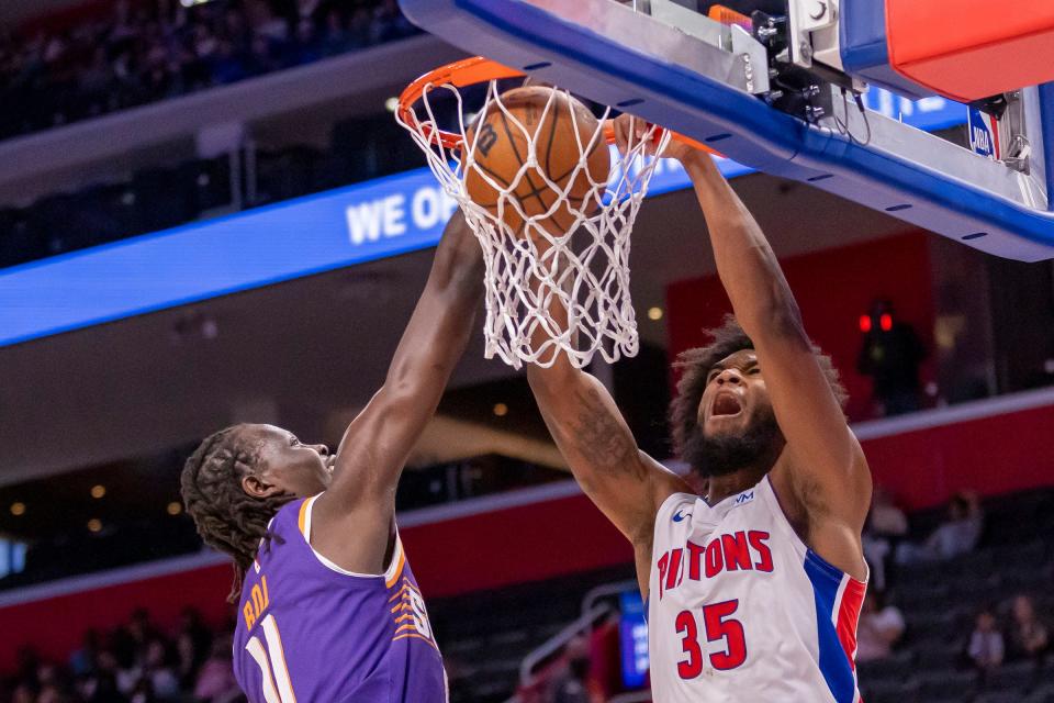 Detroit Pistons center Marvin Bagley III dunks the ball against Phoenix Suns center Bol Bol during the second half of a preseason game at Little Caesars Arena, Sunday, Oct. 8, 2023.