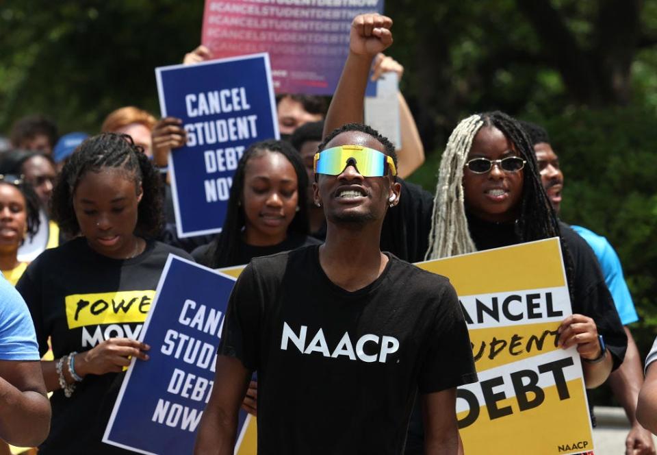 Student debt relief activists participate in a rally as they march from the U.S. Supreme Court to the White House on June 30, 2023, in Washington, DC. In a 6-3 decision the Supreme Court struck down the Biden administration's student debt forgiveness program.