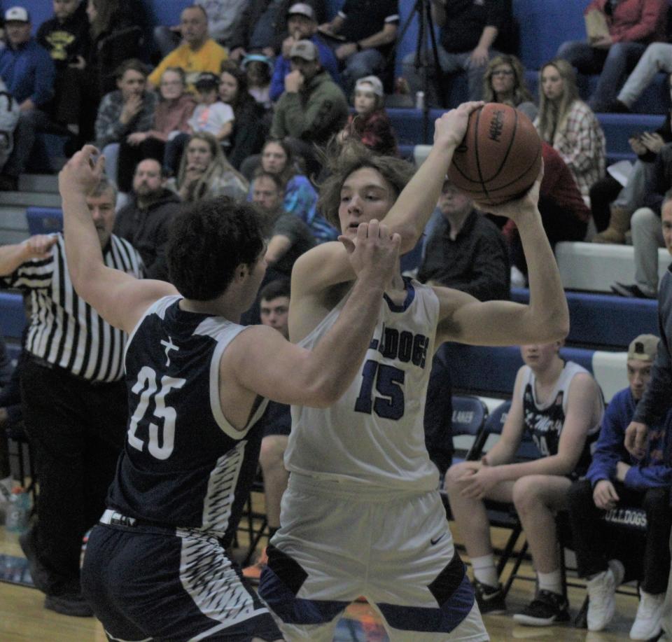 Inland Lakes junior Sam Schoonmaker (15) looks to make a decision while Gaylord St. Mary's Dillon Croff (25) defends during the first half on Tuesday.