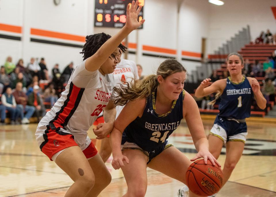 Greencastle-Antrim’s Ainsley Swindell (24) tries to move the ball around the defense of York Suburban’s Amaya Pope in the Trojans’ holiday tournament on Thursday, Dec. 28, 2023. York Suburban won 50-40.