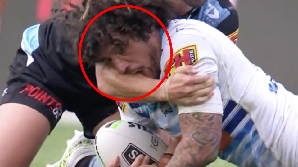 A screenshot showing Gold Coast's Kevin Proctor appearing to bite the arm of Cronulla's Shaun Johnson.