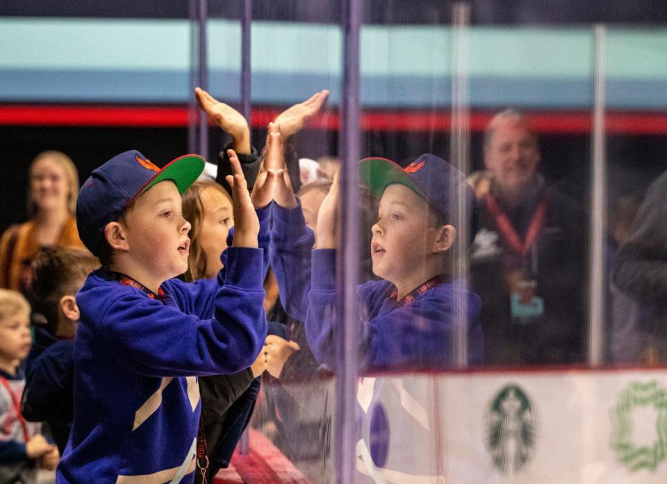 Jad Hale, 10, of Seattle cheers for the Coachella Valley Firebirds during the first period of their game at Kraken Community Iceplex in Seattle, Wash., Friday, Oct. 21, 2022. 