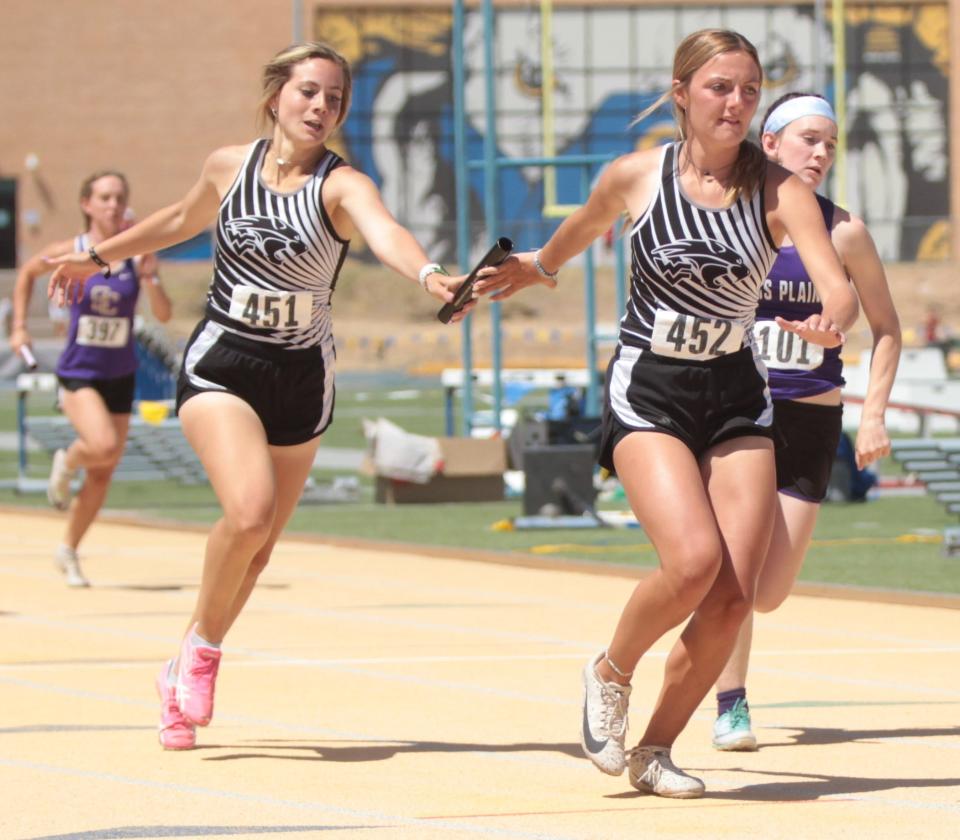 Water Valley's Kylie Bradley, left, passes the baton to Emily Crawford during the girls 4x200-meter relay at the Region II-1A Track and Field Championships Saturday, April 30, 2022, at LeGrand Stadium at Angelo State University.