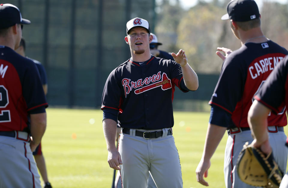 Atlanta Braves pitcher Craig Kimbrel, center, talks with fellow pitcher David Carpenter during a spring training baseball workout on Sunday, Feb. 16, 2014, in Kissimmee, Fla. The Braves agreed to terms with Kimbrel on a four-year contract. (AP Photo/Alex Brandon)