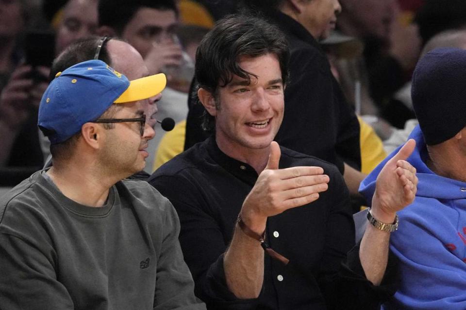 Comedian John Mulaney, right, attends an NBA basketball game between the Los Angeles Lakers and the Portland Trail Blazers on Sunday in Los Angeles with fellow comedian Joe Mande, left. Mulaney canceled his show Thursday at the Venue at Thunder Valley Casino Resort after running into travel trouble.