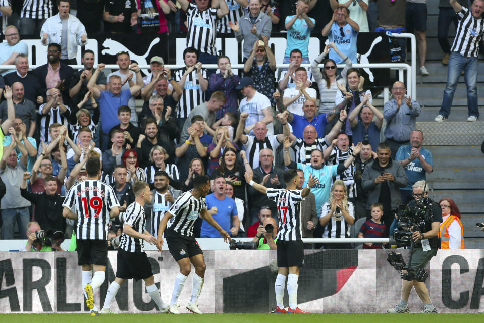 Newcastle United's Ayoze Perez, right, celebrates scoring his side's first goal of the game against Southampton during their English Premier League soccer match at St James' Park in Newcastle, England, Saturday April 20, 2019. (Richard Sellers/PA via AP)