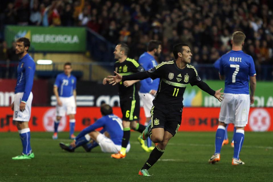 Spain’s Pedro Rodriguez, centre, celebrates his goal during a international friendly soccer match between Spain and Italy at the Vicente Calderon stadium in Madrid, Spain, Wednesday, March 5, 2014. (AP Photo/Andres Kudacki)