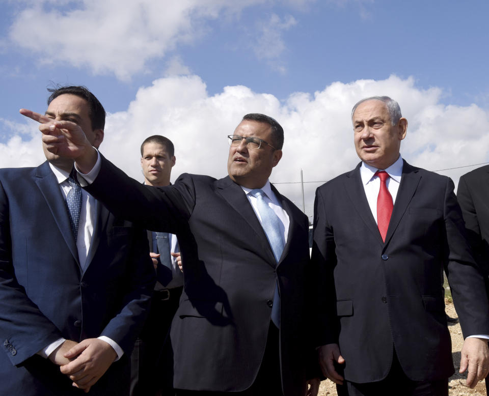 Jerusalem Mayor Moshe Leon, center, shows Israeli Prime Minister Benjamin Netanyahu where a new neighborhood of the West Bank Israeli settlement Har Homa will be built, Thursday, Feb. 20, 2020. (Debbie Hill/Pool via AP)