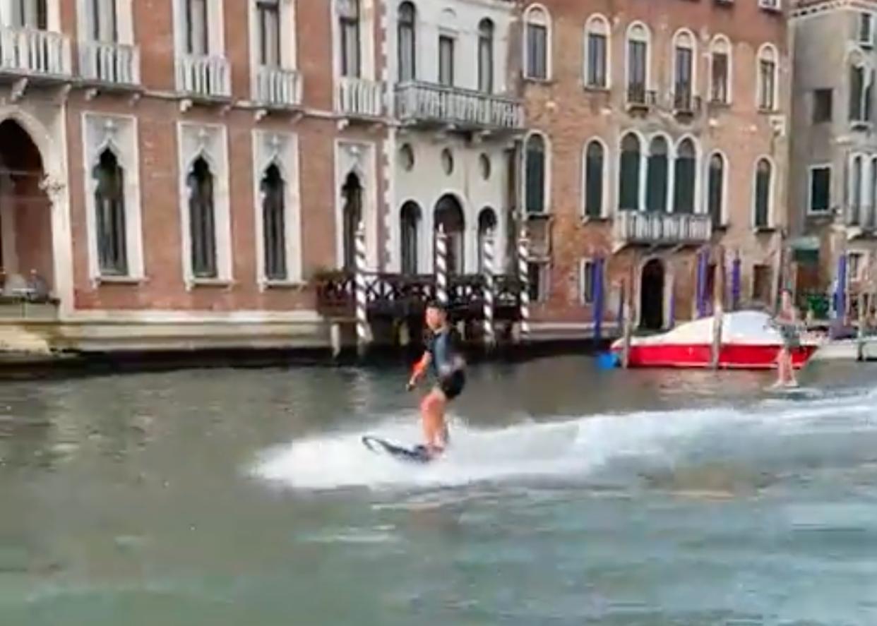 A pair of surfers were pilloried by local officials and fined after they were filmed zipping through a canal in Venice.