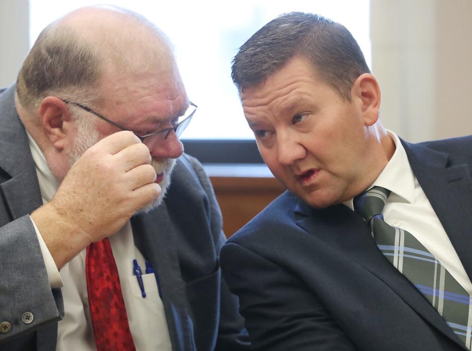 Defense attorney Mike Callahan listens to former state Rep. Bob Young before the start of his bench trial in Barberton Municipal Court on Tuesday for assault and domestic violence.