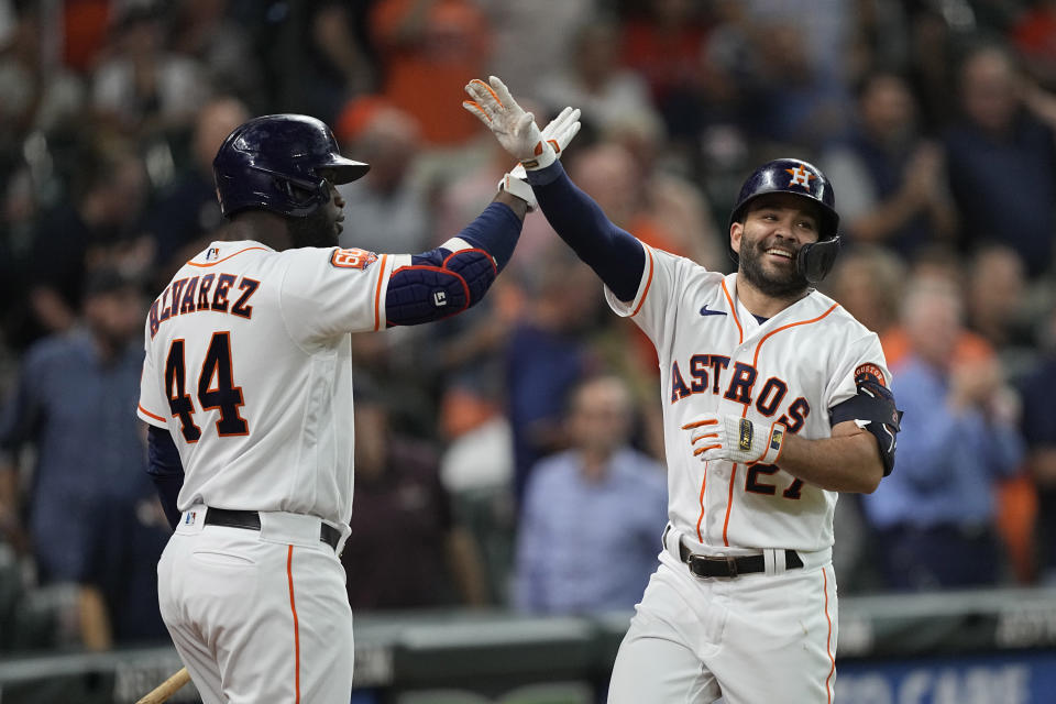 Houston Astros' Jose Altuve (27) celebrates with Yordan Alvarez (44) after hitting a home run against the Minnesota Twins during the first inning of a baseball game Wednesday, Aug. 24, 2022, in Houston. (AP Photo/David J. Phillip)