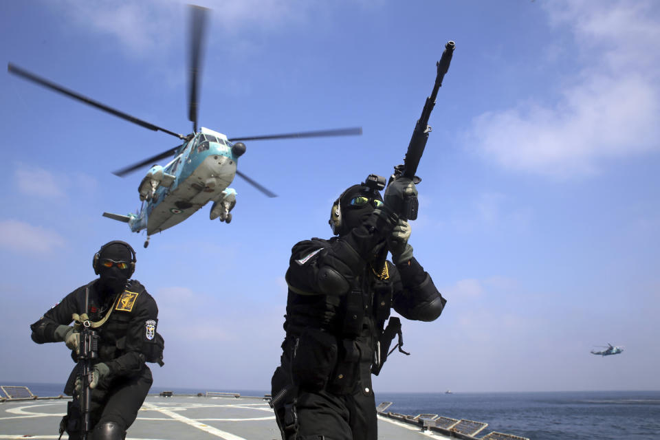 In this photo released Wednesday, Feb. 17, 2021, by the Iranian army, Iranian soldiers participate in a joint naval exercise of the Russian navy, the Iranian navy and the Iranian Revolutionary Guard's navy in the Indian Ocean. (Iranian Army via AP)