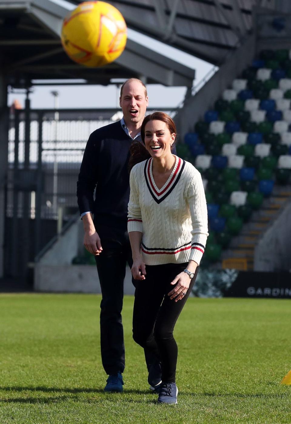 <p><em>February 27, 2019</em> — Kate Middleton let loose with Prince William on a visit to the National Stadium in Belfast, Northern Ireland. The Duchess of Cambridge opted for a cute, cable-knit <a href="https://www.ralphlauren.com/women-clothing-sweaters/pink-pony-cricket-sweater/452708.html" rel="nofollow noopener" target="_blank" data-ylk="slk:Ralph Lauren sweater;elm:context_link;itc:0;sec:content-canvas" class="link ">Ralph Lauren sweater</a> and <a href="https://www.amazon.com/dp/B01LX3SA4S" rel="nofollow noopener" target="_blank" data-ylk="slk:New Balance sneakers;elm:context_link;itc:0;sec:content-canvas" class="link ">New Balance sneakers</a>, and earlier a <a href="https://shop.nordstrom.com/s/barbour-helvellyn-quilted-jacket/5546657/lite" rel="nofollow noopener" target="_blank" data-ylk="slk:navy Barbour quilted jacket;elm:context_link;itc:0;sec:content-canvas" class="link ">navy Barbour quilted jacket</a>, for kicking around a soccer ball with two youth charities. </p>