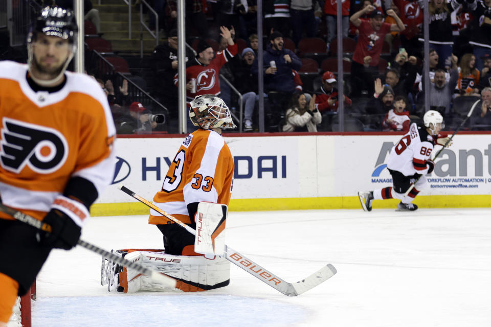 Philadelphia Flyers goaltender Samuel Ersson (33) reacts after giving up a goal to New Jersey Devils center Jack Hughes during the second period of an NHL hockey game Saturday, Feb. 25, 2023, in Newark, N.J. (AP Photo/Adam Hunger)