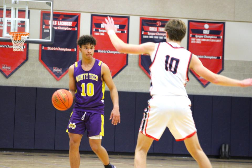 Jayden Jones brings the ball up the court against North Middlesex's Nolan Lyle. The Bulldogs defeated their opponent for their fifth victory of the season on December 27, 2023.